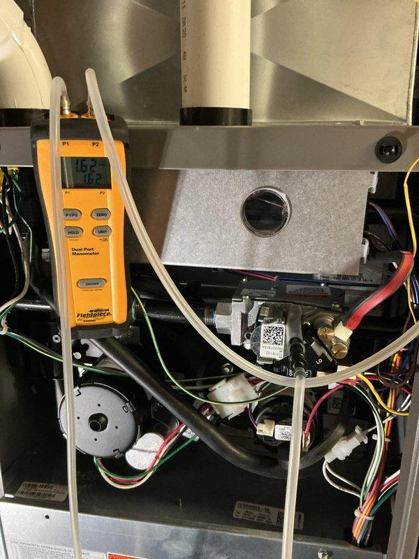 Completed comprehensive furnace maintenance on MVP heating system. Performed diagnostic testing using Fieldpiece dual port manometer to measure temperature differentials and system pressures, recording inlet temperature of 118.2°F and ambient temperature of 75.2°F. Utilized Fieldpiece SC680 clamp meter to verify electrical parameters including voltage, amperage, and resistance across motor and blower assembly. Inspected internal components including blower motor, heat exchanger, wiring harnesses, and gas valve connections. Verified proper operation of all mechanical and electrical systems, confirmed R-410A refrigerant labeling and safety warnings are present and legible. All components functioning within manufacturer specifications, no repairs required at this time.