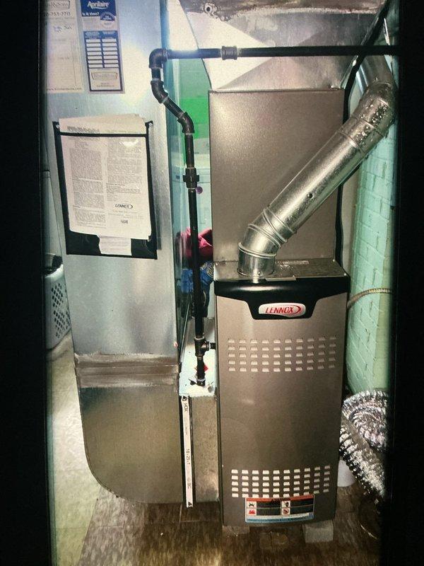 # HVAC Maintenance - Heating Service

Completed comprehensive MVP furnace maintenance on a Lennox residential heating system located in basement utility area. Performed thorough inspection of furnace cabinet, burner assembly, heat exchanger, and all associated components per manufacturer specifications. Verified proper operation of ignition system, flame sensor, and safety controls.

Inspected and documented ductwork connections, including metallic supply trunk and flex duct transitions. Examined condensate drain lines and refrigerant piping for proper installation and secure connections. Noted presence of Aprilaire air quality equipment integrated with system.

During internal component inspection, observed significant condensation accumulation on evaporator coil assembly and surrounding metallic surfaces. Heavy moisture beading pattern documented across coil housing and heat exchanger fins, indicating elevated humidity levels and temperature differential conditions. This condensation