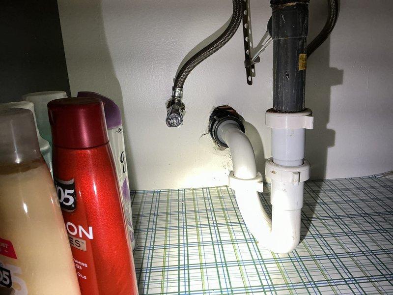 Removed cracked ABS fitting and surrounding drain pipe from the main stack. Installed new ABS piping with two no-hub fittings to tie into the main stack, along with a new 3"x1½" sanitary tee. Ran new drain piping through the wall cavity to the back bathroom vanity location and stubbed out piping at the wall for vanity connection.