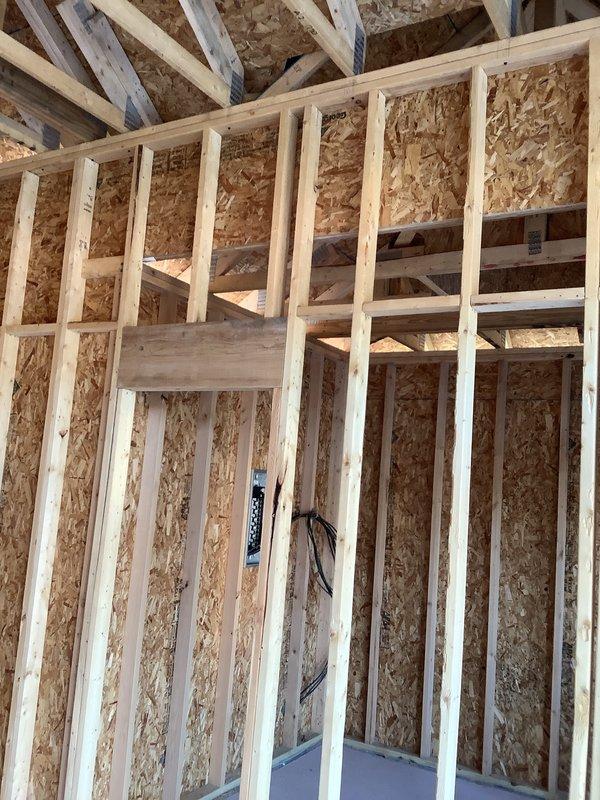 Performed site evaluation for mini split installation in new addition under construction. Assessed framing configuration, wall cavity dimensions, and electrical routing requirements. Documented interior rough framing with exposed studs, OSB sheathing, and preliminary electrical runs to determine optimal placement for indoor air handler unit and refrigerant line penetrations. Evaluated structural considerations and clearance requirements for equipment mounting and future finish work coordination.