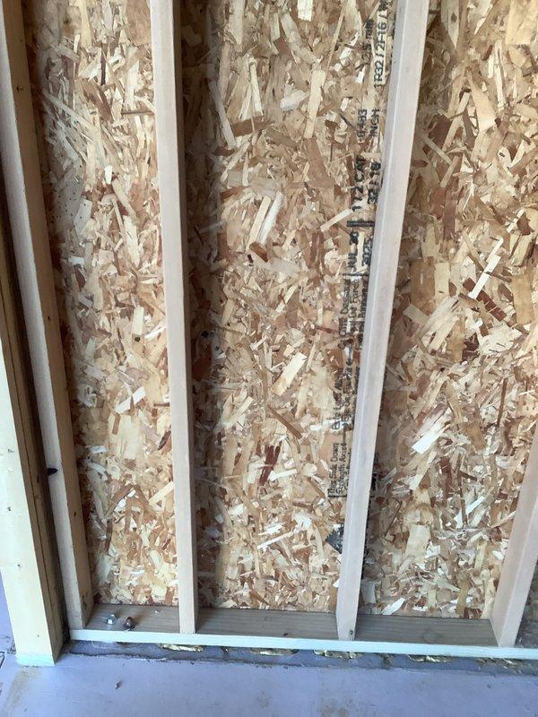Performed site evaluation for mini split installation in new addition under construction. Assessed framing configuration, wall cavity dimensions, and electrical routing requirements. Documented interior rough framing with exposed studs, OSB sheathing, and preliminary electrical runs to determine optimal placement for indoor air handler unit and refrigerant line penetrations. Evaluated structural considerations and clearance requirements for equipment mounting and future finish work coordination.
