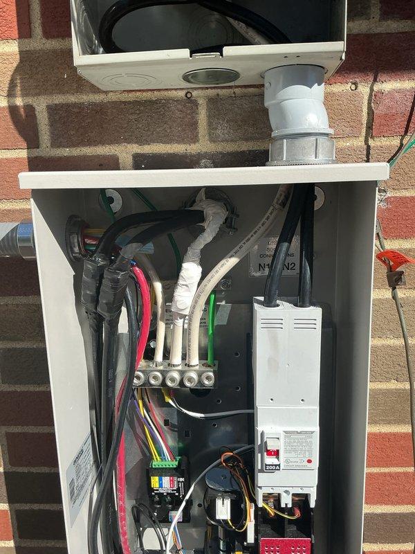Completed installation of 22KW whole home standby generator with integrated 200-amp automatic transfer switch. Ran 15 feet of gas line from existing supply to generator location and installed 10 feet of electrical conduit and wiring to establish proper power connections. Mounted transfer switch enclosure on exterior brick wall, terminated all electrical circuits including multi-conductor control wiring and power cables to manufacturer specifications, and verified proper phasing and voltage at all connection points. Connected natural gas supply line with appropriate shutoff valve and pressure testing to ensure leak-free operation. Configured generator control module, programmed automatic transfer switch settings, and performed full system testing including simulated power outage to confirm seamless transition between utility and generator power. All work completed per NEC requirements with proper grounding, bonding, and weatherproof sealing of exterior penetrations.