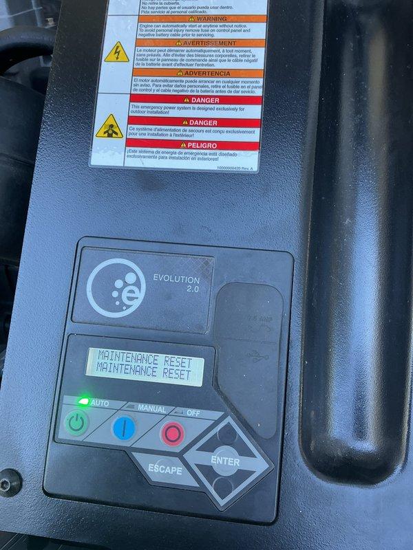 Performed routine generator maintenance on 14kW unit. Conducted battery load test using diagnostic equipment, confirming "GOOD BATTERY" status with all electrical measurements within acceptable parameters. Reset maintenance indicator on Evolution 2.0 controller and verified AUTO mode operation.