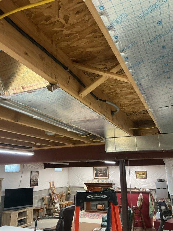 Installed a new 50-amp dedicated circuit from the existing 100-amp electrical panel to accommodate an electric range conversion from gas. Accessed the installation area by working through the cold air return and temporarily dropping the thermal pan to gain clearance behind the appliance location. Ran appropriate gauge wiring through the basement ceiling joists and up through the wall cavity. Surface-mounted a four-prong range receptacle behind the appliance location per current electrical code requirements. Verified proper circuit protection, tested voltage and polarity at the new receptacle, and confirmed all connections were secure. Restored the thermal pan and ensured all penetrations were properly sealed.