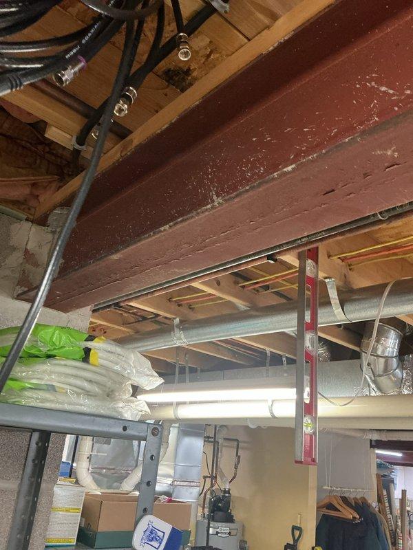 Installed a new 50-amp dedicated circuit from the existing 100-amp electrical panel to accommodate an electric range conversion from gas. Accessed the installation area by working through the cold air return and temporarily dropping the thermal pan to gain clearance behind the appliance location. Ran appropriate gauge wiring through the basement ceiling joists and up through the wall cavity. Surface-mounted a four-prong range receptacle behind the appliance location per current electrical code requirements. Verified proper circuit protection, tested voltage and polarity at the new receptacle, and confirmed all connections were secure. Restored the thermal pan and ensured all penetrations were properly sealed.