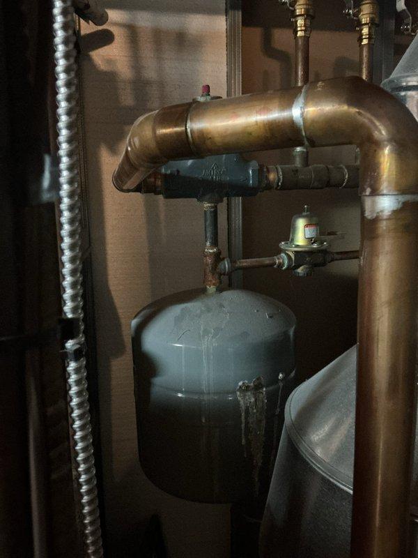 Performed second opinion inspection on a six-year-old steam gas boiler system and identified multiple critical failures requiring attention. Found failed backflow preventer, expansion tank with multiple holes causing system leaks, and temperature and pressure relief valve opening due to mineral buildup. Additionally confirmed boiler piping configuration does not meet proper installation standards and requires correction to ensure safe and efficient operation.