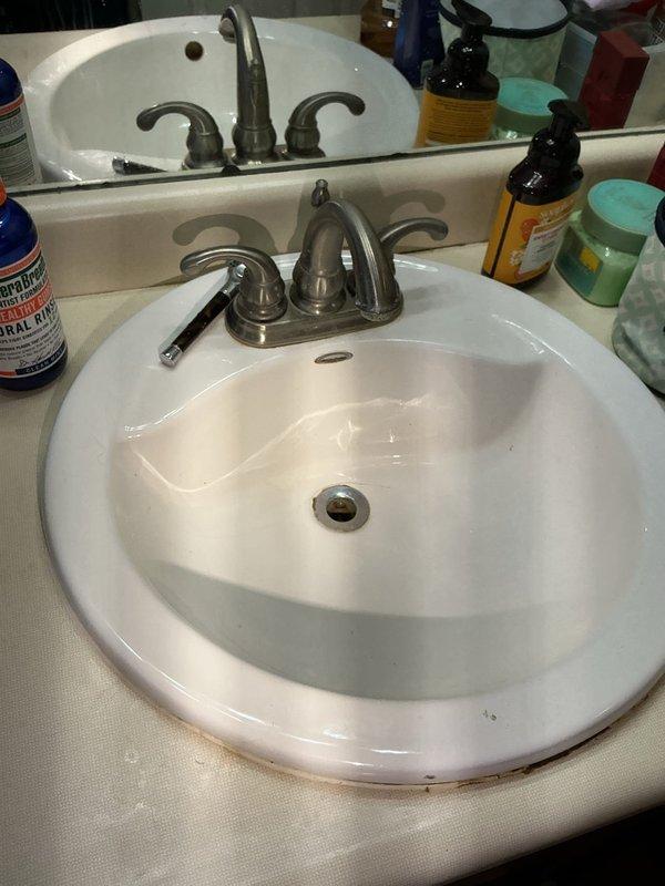 Responded to bathroom water leak complaint and performed thorough inspection of plumbing fixtures. Identified moisture accumulation at toilet base in corner area and inspected vanity plumbing connections for potential leak sources. Examined supply line connections, drain assemblies, and fixture mounting points to determine origin of water intrusion. Addressed leak issue and verified proper operation of all bathroom plumbing fixtures upon completion.
