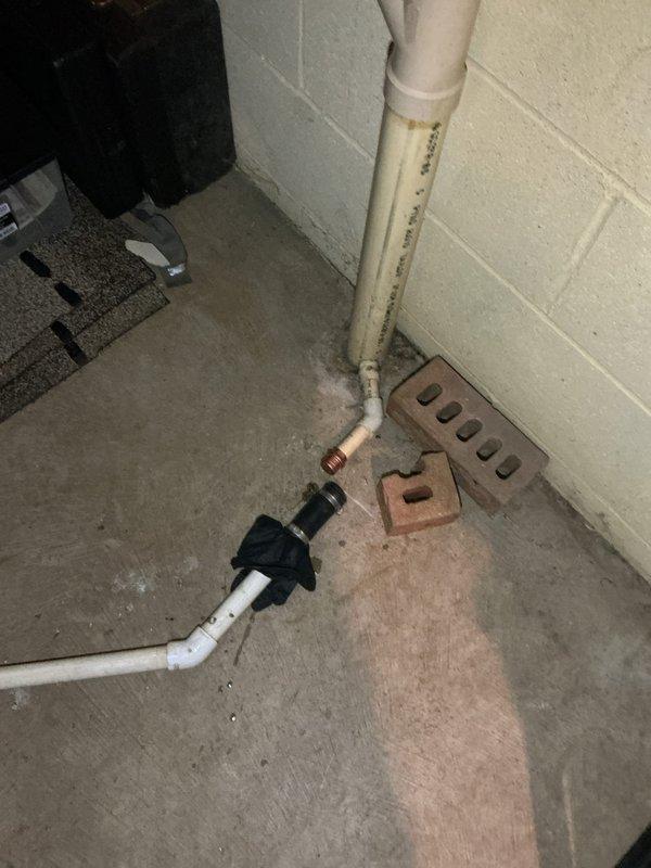 Responded to emergency call for clogged drain line connected to furnace causing water leakage and affecting kitchen sink operation and heating system. Upon arrival, inspected basement utility area and identified blockage in furnace condensate drain system with visible water damage and staining on concrete floor. Cleared obstruction from drain line, tested flow to ensure proper drainage, and verified restoration of furnace operation and kitchen sink functionality. Documented existing water damage and plumbing configuration with photographs for service records.