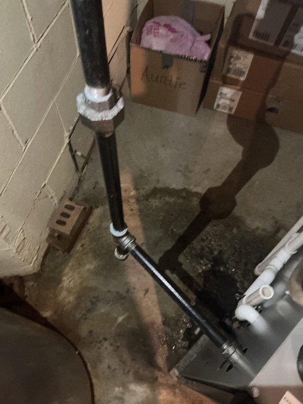Responded to emergency call for clogged drain line connected to furnace causing water leakage and affecting kitchen sink operation and heating system. Upon arrival, inspected basement utility area and identified blockage in furnace condensate drain system with visible water damage and staining on concrete floor. Cleared obstruction from drain line, tested flow to ensure proper drainage, and verified restoration of furnace operation and kitchen sink functionality. Documented existing water damage and plumbing configuration with photographs for service records.