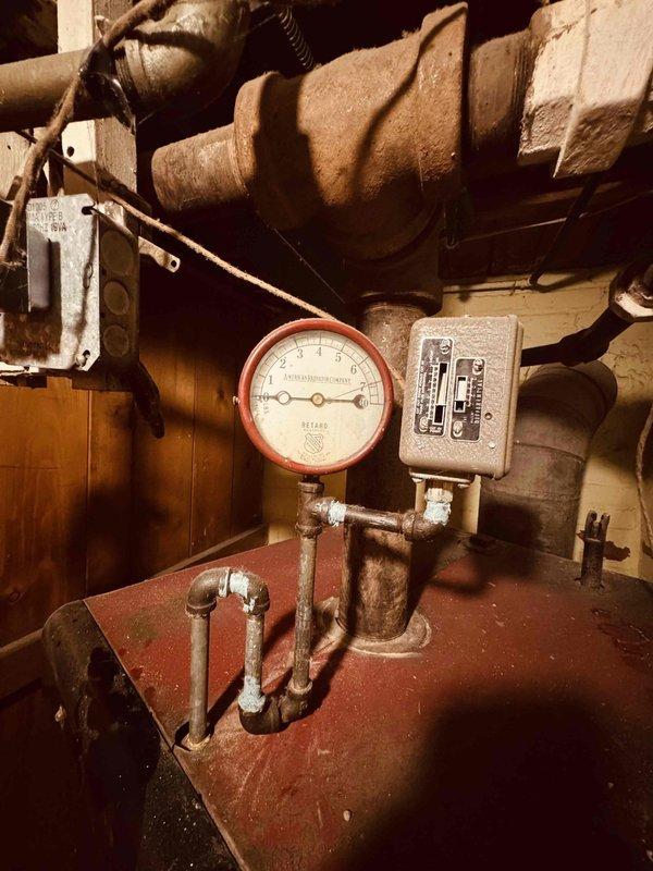 Performed comprehensive maintenance on a 98-year-old Monitor Gauge Boiler cast iron heating system. Inspection included verification of pressure gauge operation, assessment of all piping connections and fittings, examination of control components and safety devices, and evaluation of system insulation condition. All accessible components were checked for proper operation, with particular attention paid to the age and condition of this vintage Lord James Plant boiler unit to ensure continued safe operation.