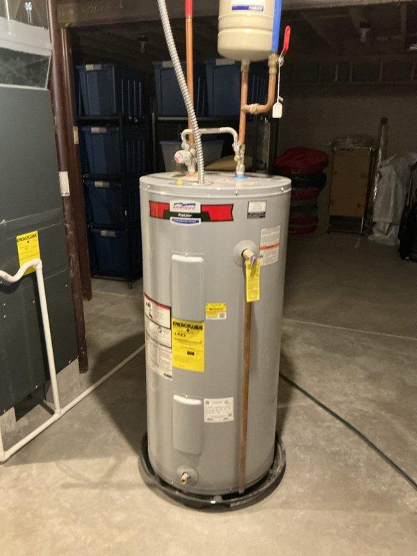 Responded to service call for leaking water heater at cold water valve connections on an 8-year-old residential unit. Upon inspection, identified active leak at cold water inlet valve, tightened connections, and verified proper sealing of braided flex connector and copper piping joints to resolve the issue.
