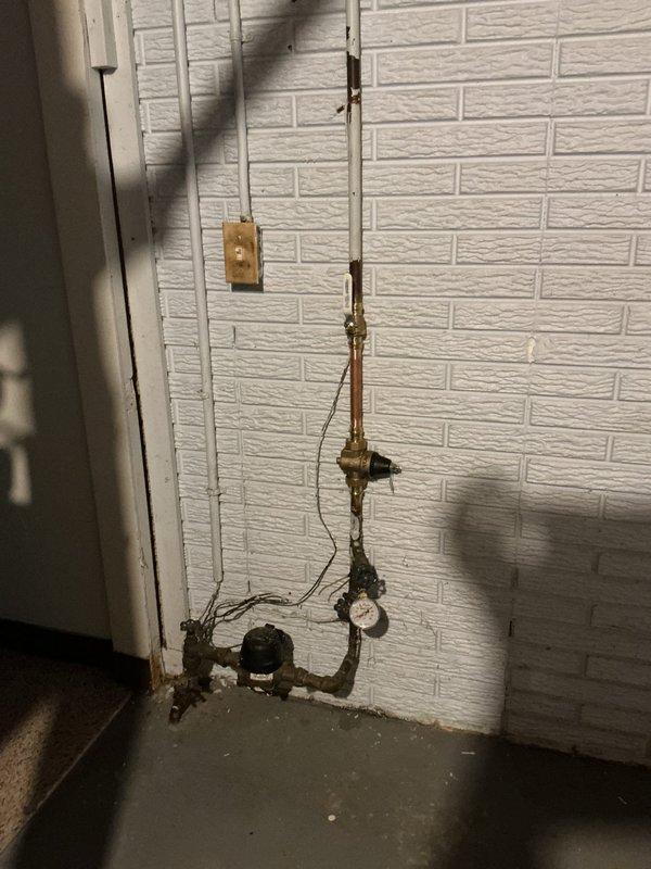 Responded to a follow-up service call to inspect a possible leak from a recently installed expansion relief tube and evaluate a suspected failing pressure reducing valve from a prior installation. Upon inspection, assessed the plumbing valve assembly and pressure regulation system mounted on the utility room wall, including the copper piping connections, pressure gauge readings, and water meter functionality. Customer confirmed the service visit and findings were documented with photographic evidence of the installation condition.