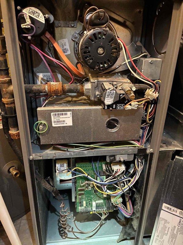 Completed comprehensive maintenance inspection on an 8-year-old gas-fired heating system located in basement. Removed access panel using hex key to gain entry to internal components. Performed thorough visual and operational assessment of blower motor assembly, gas valve, copper piping connections, and main control board. All electrical connections, wire harnesses, and circuit board terminals were inspected for proper operation. System showed normal age-related wear with minor oxidation on copper piping but all components functioning within manufacturer specifications.
