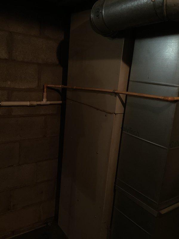 Conducted comprehensive assessment of existing 30-year-old gas furnace located in basement mechanical room for replacement estimate. Evaluated current HVAC unit condition, existing ductwork configuration including horizontal metal supply ducts, and surrounding infrastructure including copper piping and utility connections. Documented equipment specifications, measured available installation space within concrete block utility area, and photographed existing system layout to provide accurate replacement options and sizing recommendations for new high-efficiency furnace installation.