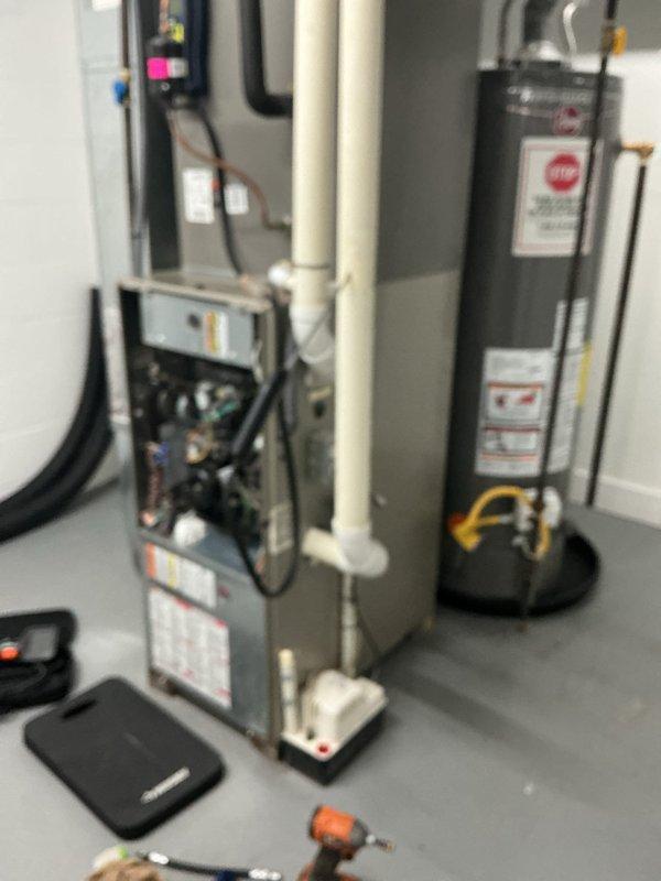 Completed recurring MVP heating maintenance visit on residential HVAC system. Performed comprehensive inspection of gas furnace and blower assembly, documenting condition of blower wheel which showed moderate dust and dirt accumulation on fan blades and housing. Verified proper operation of heating equipment, water heater connections, and associated venting systems including PVC condensate drainage lines.