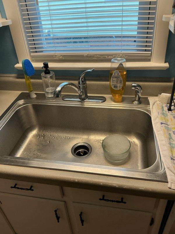 Conducted site assessment for installation of secondary faucet dedicated to filtered water system at kitchen sink location. Evaluated existing single-handle chrome faucet configuration with side sprayer, reviewed cabinet accessibility and plumbing connections beneath sink, and documented current setup including counter space availability for additional fixture mounting. Provided estimate for filtered water faucet installation including drilling requirements for countertop penetration and connection to water filtration system.