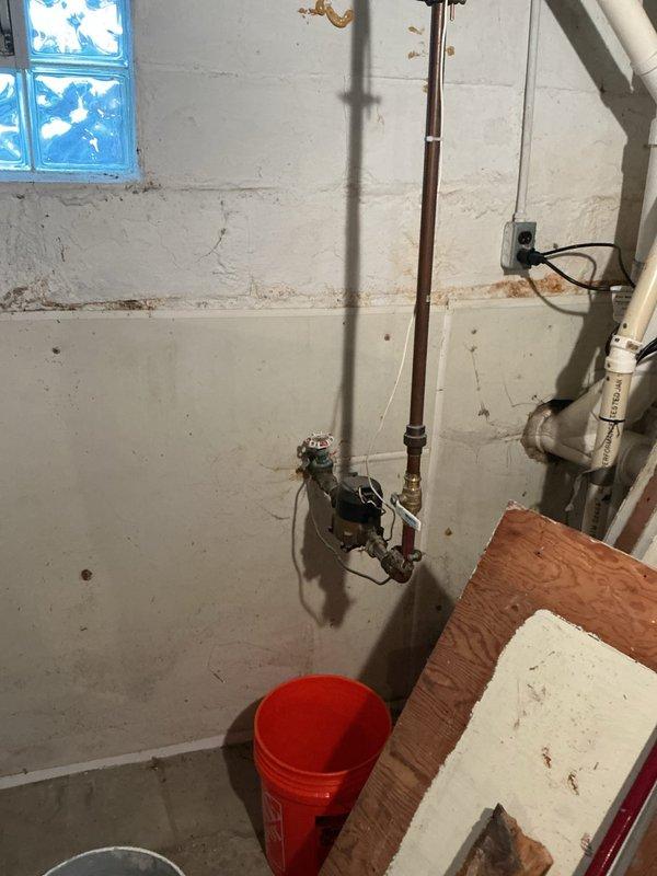Conducted comprehensive water treatment system assessment in residential basement mechanical room. Evaluated existing plumbing infrastructure including current water heater configuration and available space for installation of water softener, carbon filtration system, and tankless water heater upgrade. Documented existing HVAC and utility layout to determine optimal placement for new water treatment equipment. Collected water sample for laboratory analysis to assess hardness levels, mineral content, and contaminants requiring filtration. Photographed mechanical room configuration, gas supply lines, electrical service availability, and drainage access points necessary for equipment installation planning. Provided detailed estimate for complete water treatment system including water softener unit, whole-house carbon filter, and tankless water heating system replacement.