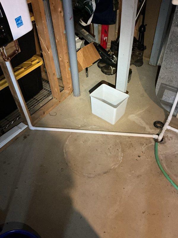 Responded to warranty callback for Navien NPE240A2 tankless water heater experiencing leak immediately following installation. Upon arrival, inspected unit mounted in basement utility area and identified water pooling on concrete floor beneath installation. Thoroughly examined all copper pipe connections, inlet/outlet fittings, and brass shut-off valves for signs of leakage. Tightened connection at inlet valve where minor seepage was detected. Pressure tested system and verified all connections were secure with no further moisture present. Cycled unit through multiple heating cycles to confirm proper operation and seal integrity. Documented installation with photographs showing unit mounting, plumbing connections, and floor conditions before departure. System operating within manufacturer specifications with no active leaks detected upon completion.