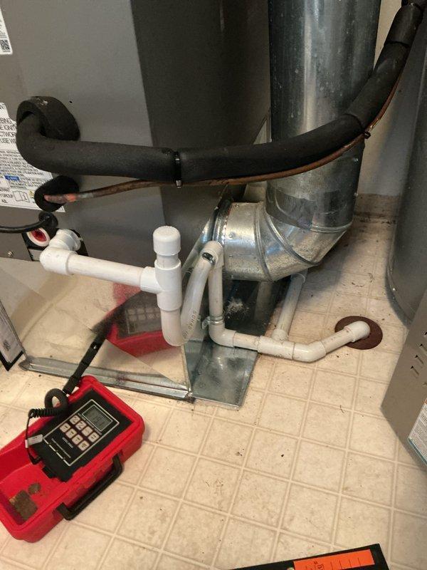 Completed full HVAC system installation including a downflow 80% efficiency gas furnace and air conditioning unit. Installed new condensate drain system with PVC P-trap configuration, secured metal drain pan at equipment base, and connected all ductwork including supply plenum and flexible return air ducting. System tested and verified operational upon completion.
