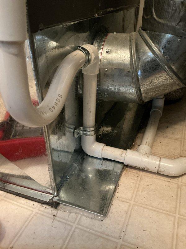 Completed full HVAC system installation including a downflow 80% efficiency gas furnace and air conditioning unit. Installed new condensate drain system with PVC P-trap configuration, secured metal drain pan at equipment base, and connected all ductwork including supply plenum and flexible return air ducting. System tested and verified operational upon completion.