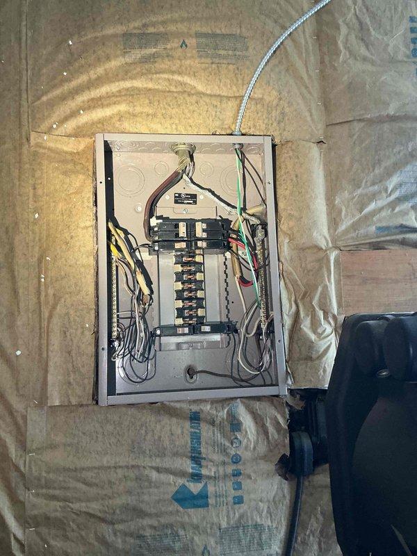 Responded to no-power condition in detached garage. Upon arrival, diagnosed issue as damaged service wire from utility pole to garage structure. Inspected exterior wiring connection at pole and traced feed line to garage electrical panel. Confirmed panel components and circuit breakers were intact but receiving no power due to compromised exterior supply wire. Documented conditions with photographs of utility pole connections and garage panel interior. Advised customer that repair requires utility company intervention to replace damaged service drop, as work involves utility-owned infrastructure beyond property meter point.