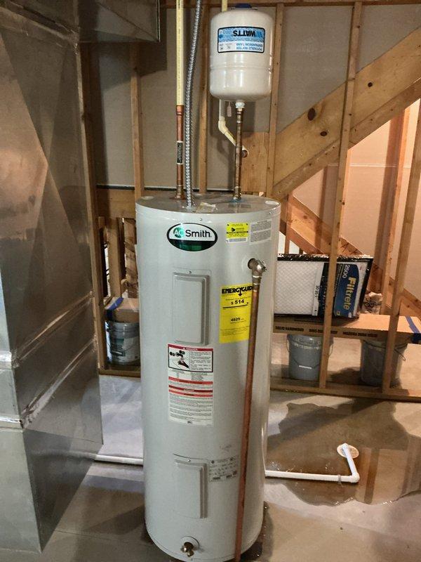 Replaced aging 14-year-old electric water heater with new 50-gallon A.O. Smith unit in residential basement utility area. Installation included proper electrical connections at the main panel, copper and flexible plumbing connections, and expansion tank integration to ensure code-compliant operation.