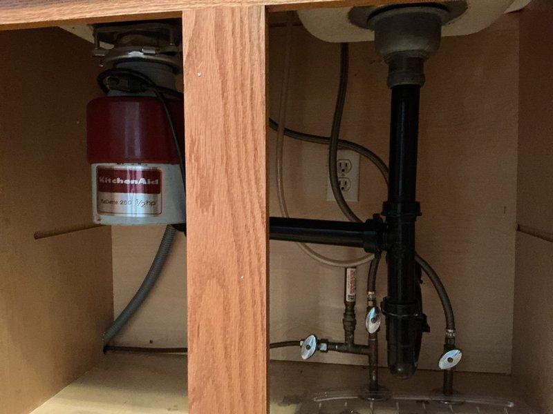Responded to service call for kitchen drain inspection and disconnection of dishwasher and garbage disposal. Upon arrival, assessed double-basin stainless steel sink installation with existing plumbing configuration. Successfully disconnected garbage disposal unit from sink drain assembly and electrical supply. Disconnected dishwasher drain line from disposal unit and water supply connections. Removed disposal mounting hardware from sink flange. Capped drain lines as necessary to prevent leaks. Verified all shut-off valves were properly closed and inspected P-trap assembly for proper drainage. Left under-sink cabinet area clean and organized with all disconnected components accessible for customer. Kitchen sink remains functional for standard drainage use.