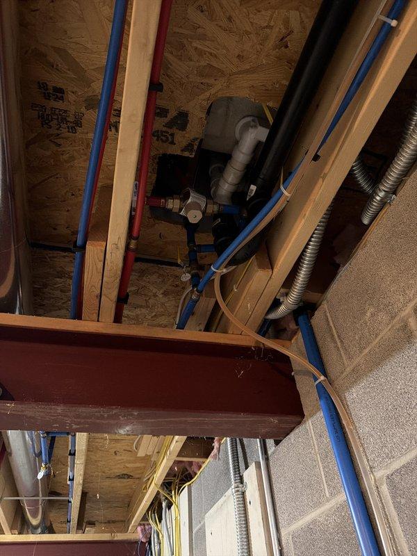 Replaced 3/4" mixing valve, ball valve, and associated piping at walk-in tub installation. Installed new Flexlite pressure tank with tee package and connecting piping, integrating system with existing water treatment equipment including filtration units. Routed blue PEX supply lines through ceiling joists and secured with appropriate clips. All necessary parts were coordinated through suppliers and delivered to complete installation. System tested and verified operational upon completion.