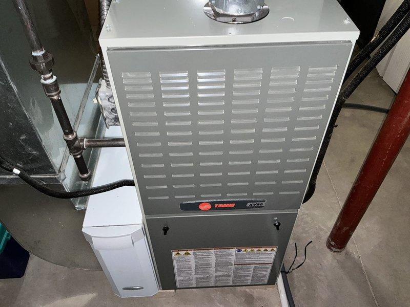 Performed estimate for furnace replacement on 12-13 year old Trane unit after identifying cracked heat exchanger during inspection. Documented existing system configuration including ductwork connections, venting, and mechanical room layout with photos, and provided quote for complete furnace replacement due to safety concerns associated with heat exchanger failure.