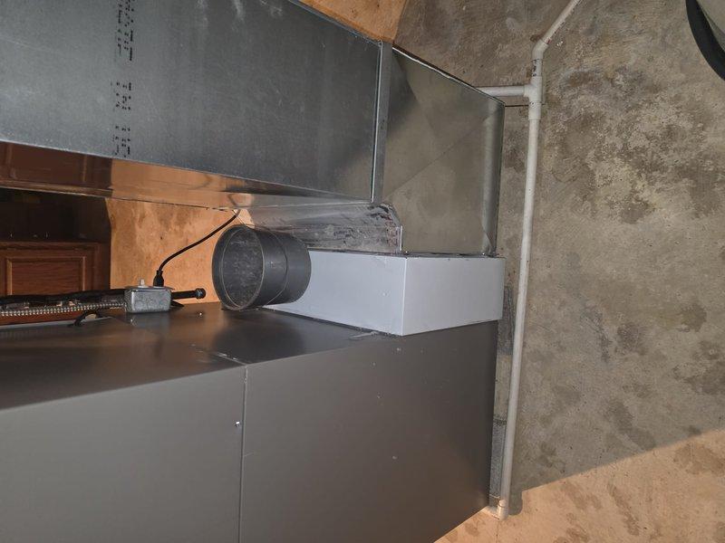 Completed installation of new HVAC system with indoor air quality equipment in basement utility area. Installed air handler unit, ductwork system including rectangular metal supply ducts and flexible round duct connections, integrated IAQ components with existing mechanical systems, ran electrical connections and control wiring between units, and installed PVC condensate drain piping. All equipment mounted and secured to manufacturer specifications with proper clearances for service access.