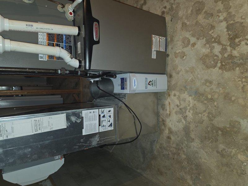 Completed installation of new HVAC system with indoor air quality equipment in basement utility area. Installed air handler unit, ductwork system including rectangular metal supply ducts and flexible round duct connections, integrated IAQ components with existing mechanical systems, ran electrical connections and control wiring between units, and installed PVC condensate drain piping. All equipment mounted and secured to manufacturer specifications with proper clearances for service access.