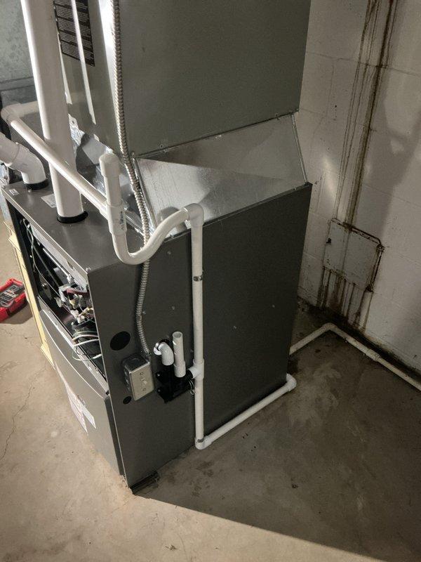 Installed a new gas furnace with galvanized plenum and ductwork connections, PVC combustion air/vent piping, and a condensate drain assembly with pump. Reused the existing gas shutoff valve and supply piping, and completed the flexible conduit and electrical disconnect connections. Verified all connections and furnace operation upon completion.