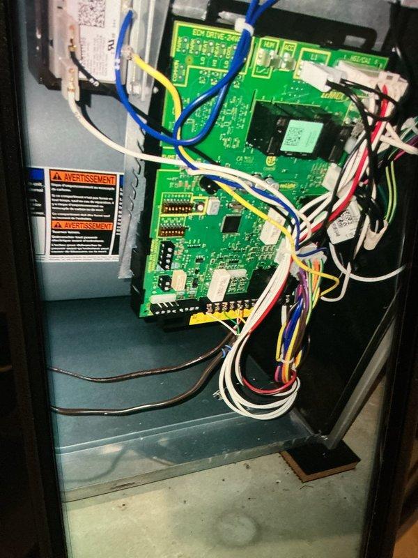 Performed a heating maintenance inspection of the furnace/air handler, including a visual check of the ECM drive control board, low-voltage wiring, and cabinet for signs of rust, damage, or loose connections, with none observed. Identified heavy frost and ice accumulation on the evaporator coil and copper refrigerant lines, indicating a restricted airflow or low refrigerant charge condition, and documented the corroded drain pan for further evaluation and corrective repair.
