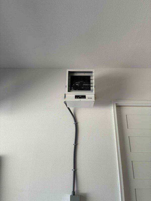 Installed a dedicated circuit from the main electrical panel to the garage to serve a new wall-mounted electric unit heater, fishing the wiring through the structure to minimize wall damage. Mounted a disconnect switch at the heater location and connected the unit with a flexible metal conduit whip, leaving the installation secure, properly supported, and ready for operation.