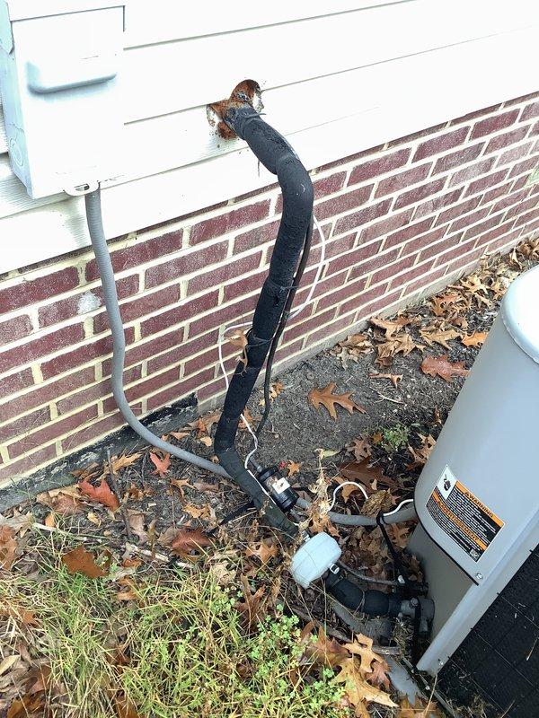 Performed an on-site evaluation for replacement of the existing 29–30 year old HVAC system, inspecting the indoor air handling equipment, galvanized supply ductwork, insulated copper refrigerant lines, condensate drain piping, and the outdoor condensing unit with its electrical disconnect. Noted heavy rust staining and corrosion at the refrigerant line wall penetration, along with uneven and deteriorated line set insulation, which should be addressed during replacement. No active system failures were identified at the time of inspection, and the equipment is being evaluated for proactive replacement due to age.