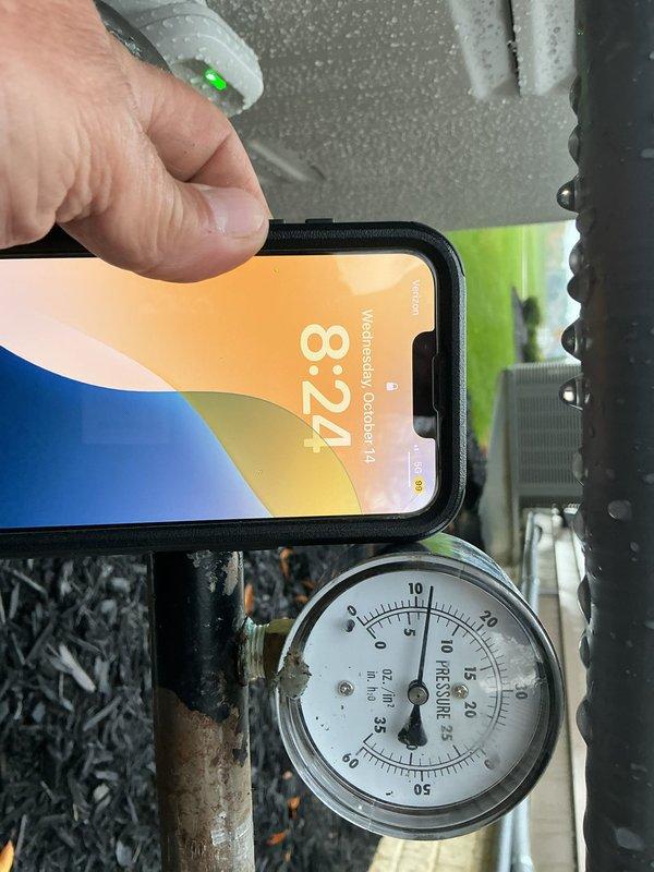 Disconnected the gas supply line to the standby generator and installed a low-pressure test gauge to initiate an air pressure test on the gas piping. Verified the gauge reading was stable at approximately 10 oz/in² following installation, with the system left under test pending inspection and scheduled for return to remove the gauge and restore the connection.