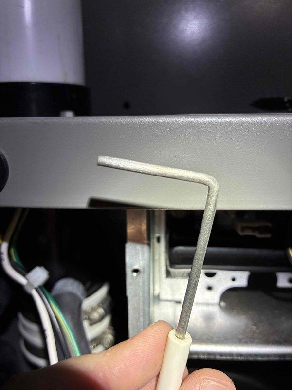 Performed scheduled heating maintenance on a 3-year-old furnace. Removed the flame sensor, which showed heavy mineral and oxidation buildup, and cleaned the rod with an abrasive pad to restore proper flame rectification and reliable ignition. Inspected the surrounding burner compartment, wiring harness, and condensate/vent connections, and found them in serviceable condition.