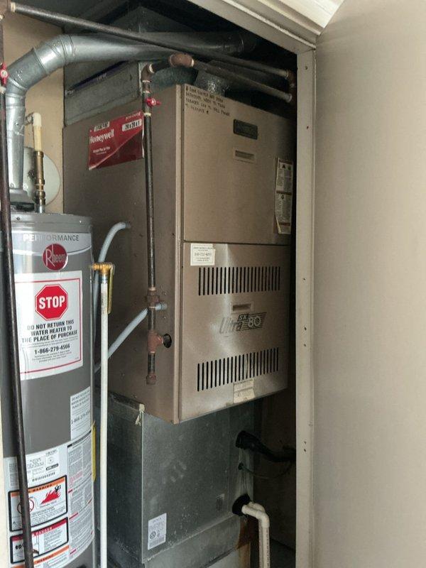Responded to a service call to evaluate the gas control valve on a gas-fired furnace (Ultra 80). Removed the front access panel and inspected the valve, wiring, gas supply piping, blower assembly, and burner compartment, observing normal burner flame with heavy dust and debris buildup on interior surfaces. Documented the unit's condition with photos and prepared an estimate for gas valve replacement.