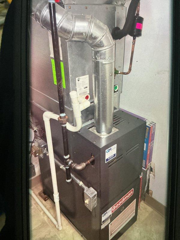 Performed seasonal heating tune-up on a Goodman gas furnace, including inspection of the flue, gas supply piping, condensate drain, and electrical connections. Removed and inspected the flame sensor, which showed discoloration and wear, and cleaned it to restore proper flame rectification. Verified safe, normal furnace operation and confirmed the system is operating properly.