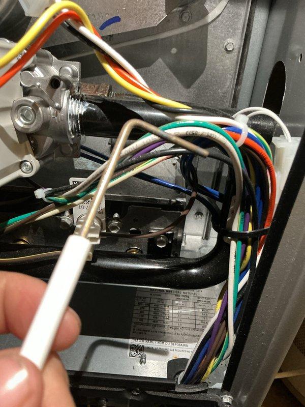 Performed annual furnace maintenance on a 1-year-old gas furnace, including inspection of the control compartment, wiring harness, circuit board connections, gas valve, and gas piping. Removed and inspected the flame sensor, and cleaned light dust and debris from the cabinet interior. Noted unterminated wire ends in the control compartment, and found no signs of rust, frost, or component breakage.