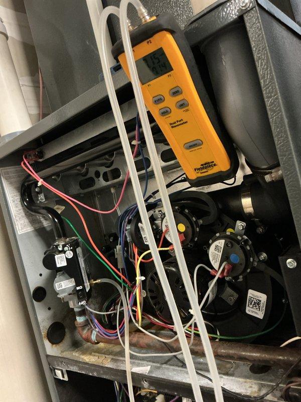 Performed annual heating maintenance on the gas furnace, including inspection of the draft inducer assembly, pressure switches, gas valve, and vent transition, and verified gas pressure and draft readings with a dual-port digital manometer. Inspected and cleaned the flame sensor and checked the integrated control board and wiring harness for proper connections, with no damage observed. Noted light surface rust and dust accumulation on the cabinet interior and corrosion on a copper line, which should be monitored at future visits.