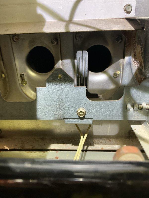 Performed annual maintenance on a 26-year-old gas furnace, inspecting the burner assembly, heat exchanger inlets, gas valve and manifold, inducer motor, flame sensor, and control wiring. Noted surface corrosion and staining in the burner compartment and cleaned debris from the cabinet and burner area. Per the customer's note, the two front-door buttons were tested, with one operating and one not; the nonfunctioning button is recommended for further diagnosis and repair.