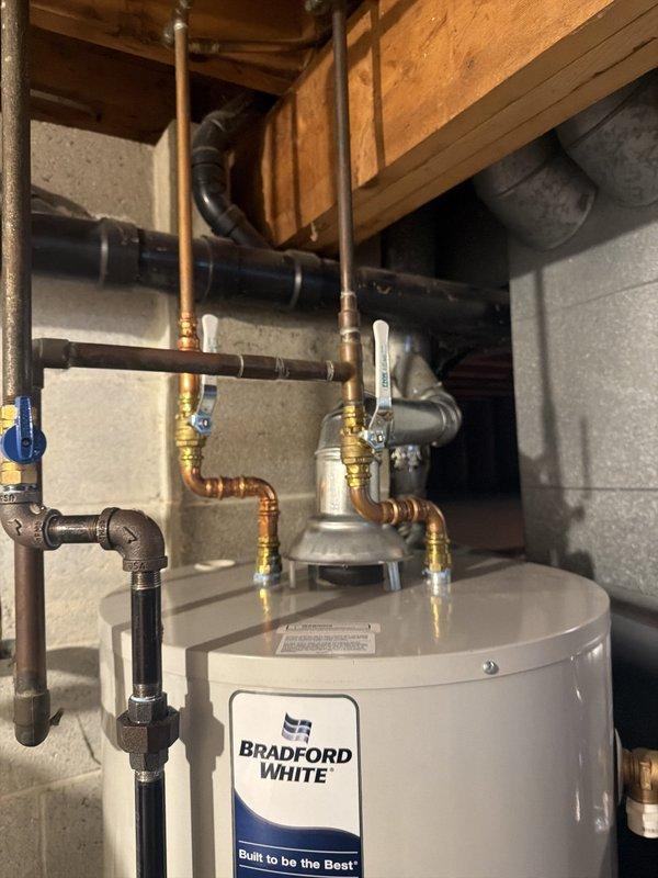Performed an on-site evaluation of a Bradford White 50-gallon atmospheric-vent gas water heater (Model RG250T6N-264) to diagnose a reported sulfur odor. Inspected the tank, supply lines, isolation valves, gas connection, and flue/draft hood and found the unit to be in good condition with no visible leaks, corrosion, or damage. Verified the unit is registered with an active 6-year tank and parts warranty, and noted that the sulfur smell is consistent with bacterial reaction in the tank, which is commonly addressed by flushing, disinfection, or anode rod replacement.