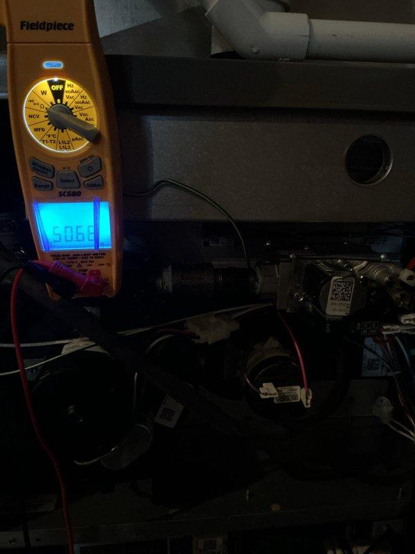 Performed a scheduled heating maintenance visit, inspecting the furnace control board wiring and neutral connections and finding no signs of damage, corrosion, or overheating. Used a clamp meter to perform electrical diagnostics at the gas valve and wiring harness area, with no visible deficiencies noted in the cabinet interior.