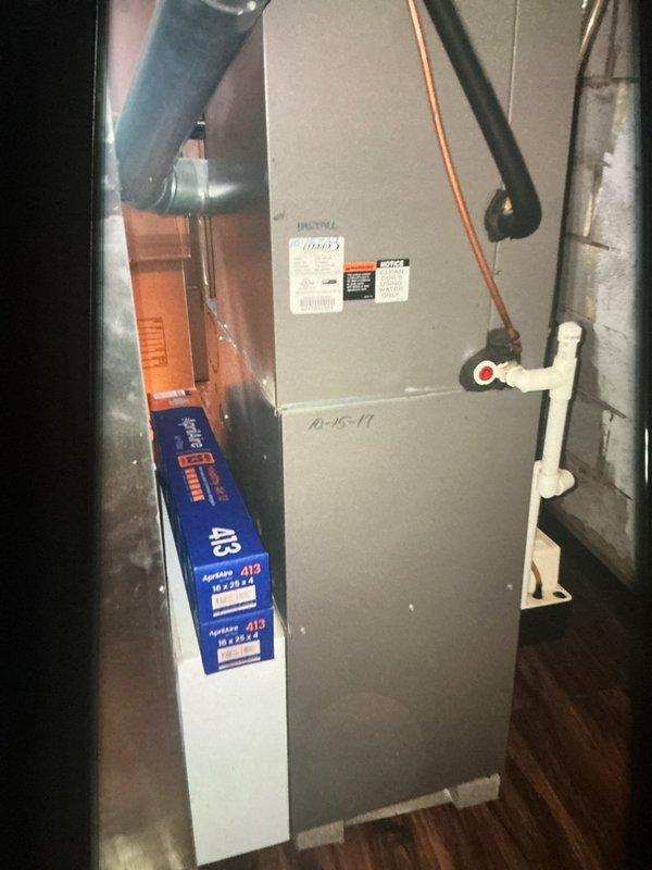 Performed a scheduled heating maintenance visit on a gas furnace, inspecting the cabinet, inducer motor, wiring harness, drain line, and refrigerant line connections for wear or damage. Verified gas valve manifold pressure with a digital manometer and confirmed proper operation, and checked the Aprilaire 16x25x4 media filter assembly for serviceability. Equipment was found operating normally with no visible rust, frost, or damage.