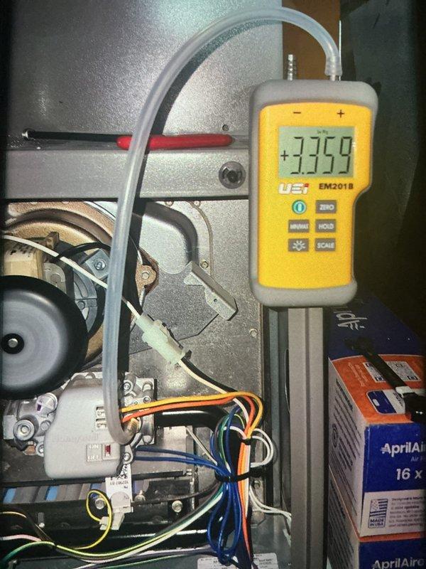 Performed a scheduled heating maintenance visit on a gas furnace, inspecting the cabinet, inducer motor, wiring harness, drain line, and refrigerant line connections for wear or damage. Verified gas valve manifold pressure with a digital manometer and confirmed proper operation, and checked the Aprilaire 16x25x4 media filter assembly for serviceability. Equipment was found operating normally with no visible rust, frost, or damage.