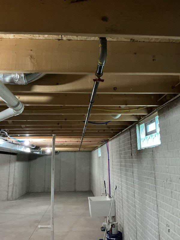 Installed a 22 kW standby generator with a 200-amp automatic transfer switch, including approximately 30 feet of gas line piping and 50 feet of electrical feeder run to connect the generator to the service panel. Gas piping was routed through the basement joist space with a shutoff valve and connected to the generator fuel supply, and the system was commissioned to confirm proper transfer and operation.