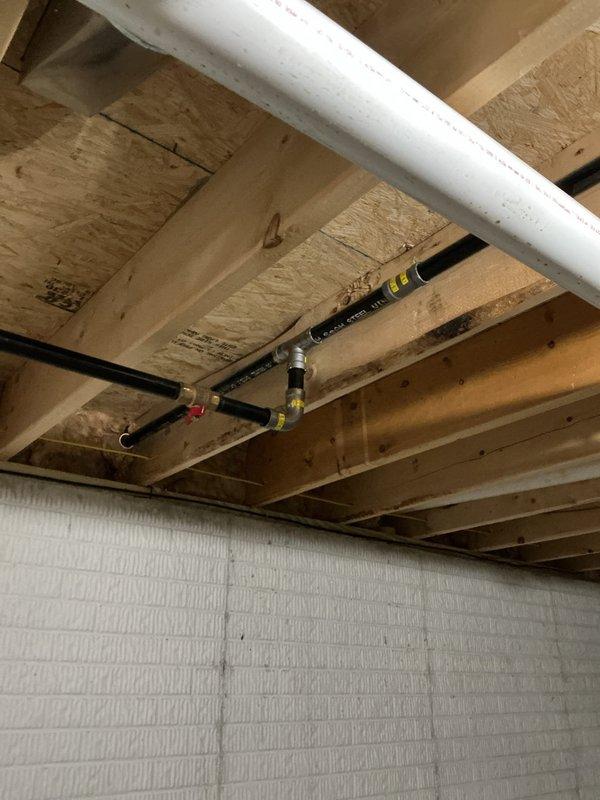 Installed a 22 kW standby generator with a 200-amp automatic transfer switch, including approximately 30 feet of gas line piping and 50 feet of electrical feeder run to connect the generator to the service panel. Gas piping was routed through the basement joist space with a shutoff valve and connected to the generator fuel supply, and the system was commissioned to confirm proper transfer and operation.