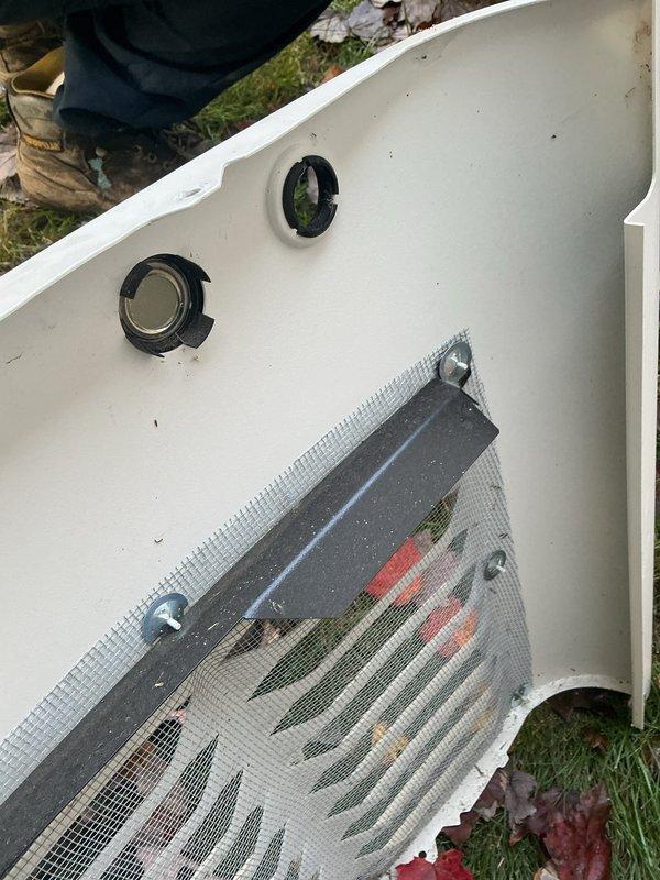 Performed scheduled maintenance on a 3-year-old Generac 14kW standby generator, including removal of the enclosure cover to inspect and service the unit's interior components. Cleared accumulated leaves and debris from the louvered intake vent and wire mesh screen to ensure proper airflow and cooling, then reinstalled the cover panel.