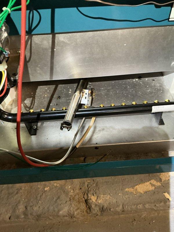 Performed a tune-up on a one-year-old gas-fired boiler, inspecting the burner assembly, gas manifold and orifices, ignitor/flame sensor, and associated wiring, and clearing dust and debris from the burner compartment. Verified the circulator pump, pressure/temperature gauge, relief valve and discharge piping, copper connections, and gas valve for proper condition, with no leaks, rust, or damage observed. System was left in good operating condition.